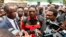 Opposition United Party for National Development president Hakainde Hichilema (C) talks to journalists before being dispersed with supporters athe Woodlands Police Station in Lusaka on March 2, 2016.