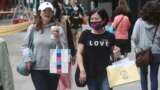 People wear face masks to protect against the spread of the coronavirus as they walk through a shopping district in Taipei, Taiwan, Thursday, Oct. 29, 2020. (AP Photo/Chiang Ying-ying)