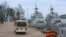 FILE - Buses carrying journalists drive on the jetty mooring warships during a rare media tour of Cambodia’s Ream Naval Base, in Sihanoukville, Cambodia, Friday, July 26, 2019. (Sophat Soeung/VOA Khmer)