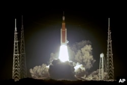 NASA's new moon rocket lifts off from Launch Pad 39B at the Kennedy Space Center in Cape Canaveral, Fla., Wednesday, Nov. 16, 2022. This launch is the first flight test of the Artemis program. (AP Photo/John Raoux )