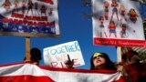 People hold an American flag during the second annual Women's March in Los Angeles, California, Jan. 20, 2018. 