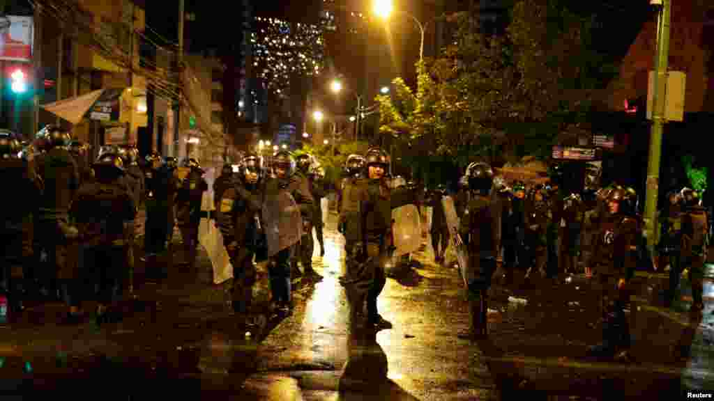 Policías antidisturbios se enfrentan a los manifestantes. 