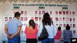 FILE - Photographs of the missing are on display at the future site of the Victims' City in Iguala, Guerrero State, Mexico, Nov. 22, 2016.