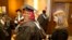 Mariama Bassama is helped with her hood by Charlotte Pandraud before the 2016 graduation ceremony for Hult International Business School, in Boston.
