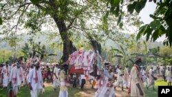 Villagers participate in a religious procession during the traditional Gohain Uliuwa Mela in Mayong village, about 50 kilometers (31 miles) east of Gauhati, India.
