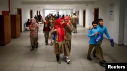 Students of Tevfik Ileri Imam Hatip School walk along a corridor as they leave their classroom for a break in Ankara, Nov. 18, 2014.