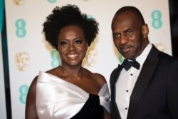 FILE - Viola Davis and Julius Tennon pose for photographers upon arrival at the BAFTA Film Awards in London, Feb. 10, 2019.