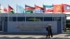 Participants walk outside of the Sharm El Sheikh International Convention Centre before the COP27 climate summit opening in Egypt's Red Sea resort of Sharm el-Sheikh, Egypt Nov. 6, 2022. 