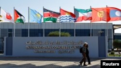 Participants walk outside of the Sharm El Sheikh International Convention Centre before the COP27 climate summit opening in Egypt's Red Sea resort of Sharm el-Sheikh, Egypt Nov. 6, 2022. 