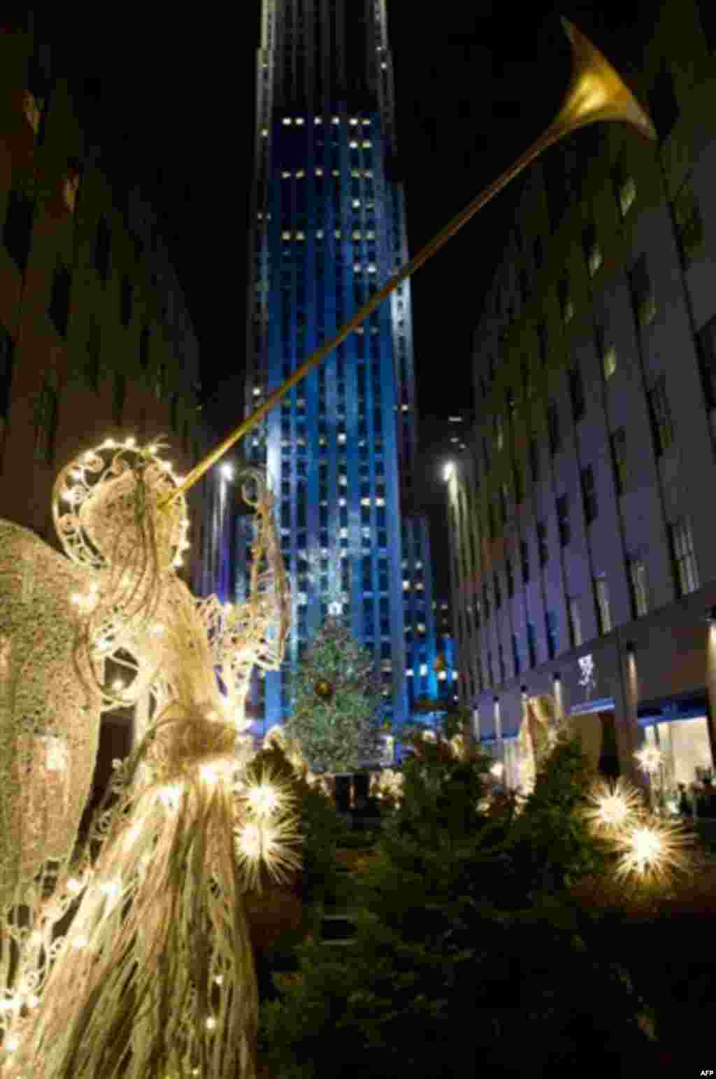 The 74-foot-tall Rockefeller Center Christmas tree is lit using 30,000 energy efficient LED lights during the 79th annual lighting ceremony, in New York, Wednesday, Nov. 30, 2011. (AP Photo/Charles Sykes)