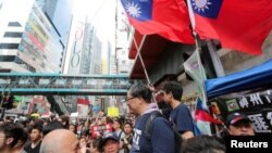 Taiwan flags are seen near protesters attending a demonstration to demand the resignation of Hong Kong leader Carrie Lam and the withdrawal of the extradition bill, in Hong Kong, China June 16, 2019. REUTERS/James Pomfret