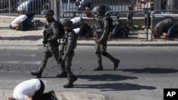 FILE —Israeli police patrols as Palestinian Muslim worshipers who were prevented from entering the Al-Aqsa Mosque pray outside Jerusalem's Old City, November10, 2023.