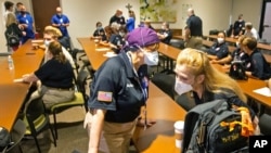 A nurse from Maryland chats with a nurse from Chattanooga, Tenn., as nearly three dozen health care workers from around the country arrive to help supplement the staff at Our Lady of the Lake Regional Medical Center in Baton Rouge, Aug. 2, 2021.