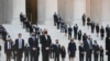 People wait for the casket of the late Supreme Court Justice Ruth Bader Ginsburg to arrive at the U.S. Supreme Court in Washington.