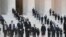 People wait for the casket of the late Supreme Court Justice Ruth Bader Ginsburg to arrive at the U.S. Supreme Court in Washington.