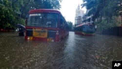 Buses are stranded on a waterlogged road during heavy rain in Mumbai, India, May 17, 2021. 