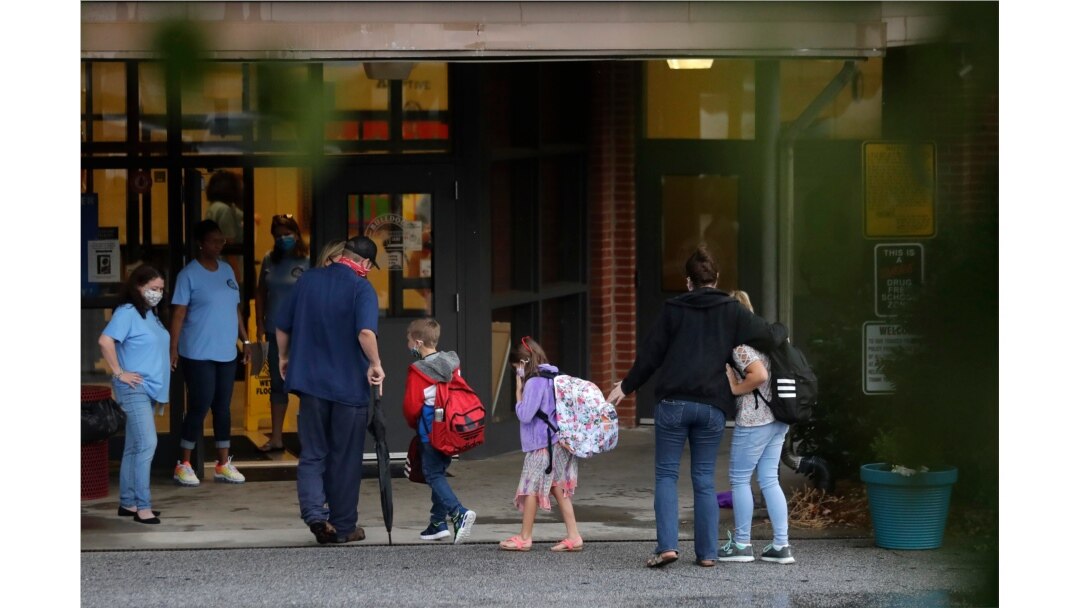 Students arrive to Dallas Elementary School for the first day of school amid the coronavirus outbreak on Monday, Aug. 3, 2020, in Dallas, Ga.