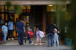 Students arrive to Dallas Elementary School for the first day of school amid the coronavirus outbreak on Monday, Aug. 3, 2020, in Dallas, Ga.