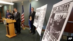 FILE - Feb. 26, 2020, Raymond Duda, FBI Special Agent in Seattle, speaks about charges against a group of alleged members of the neo-Nazi group Atomwaffen for cyber-stalking, mailing threatening communications, including the Swastika-laden posters. 