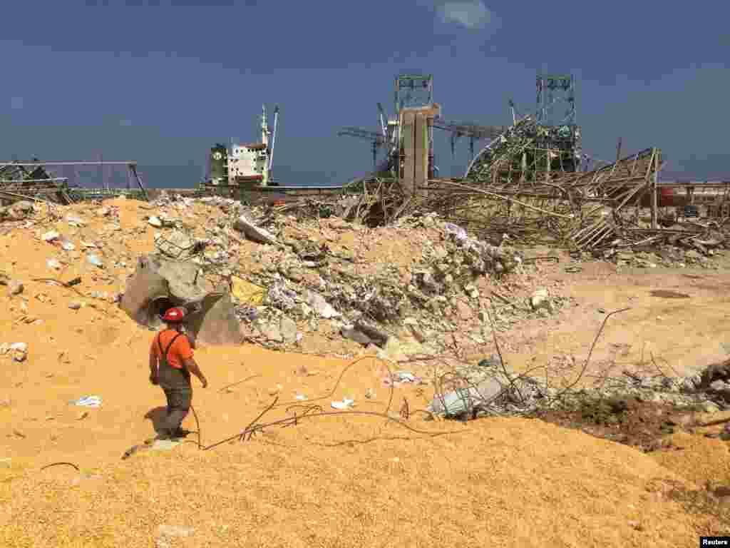 A man walks near rubble at the site of Tuesday's blast, at Beirut's port area, Lebanon.