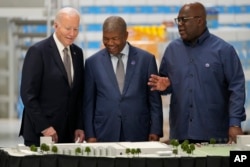 U.S. President Joe Biden, accompanied by Angolan President Joao Lourenco, center, and President Felix Tshisekedi of the Democratic Republic of the Congo, visits the Carrinho food processing factory near Lobito, Angola, Dec. 4, 2024.