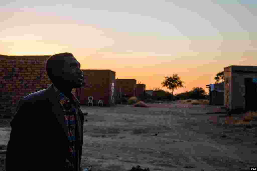 A Nuban man watches the sky as an Antonov bomber fly’s over head. (Adam Bailes/VOA News)