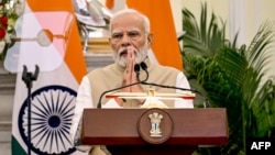 FILE - India's Prime Minister Narendra Modi gestures during a media briefing at Hyderabad House in New Delhi, Oct. 7, 2024.