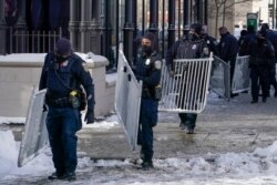 Police set up barricades prior to the arrival of President Joe Biden, outside The Pabst Theater in Milwaukee, Wisconsin, Feb. 16, 2021.