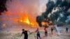 Firemen and local volunteers extinguish a wildfire in Oren, in the vacation region of Mugla, Aug. 6, 2021, as Turkey struggles with its deadliest wildfires in decades.