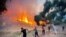 Firemen and local volunteers extinguish a wildfire in Oren, in the vacation region of Mugla, Aug. 6, 2021, as Turkey struggles with its deadliest wildfires in decades.
