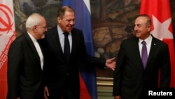 Foreign Ministers Mohammad Javad Zarif of Iran, Sergey Lavrov of Russia and Mevlut Cavusoglu of Turkey gather for a photo following their meeting in Moscow, April 28, 2018.