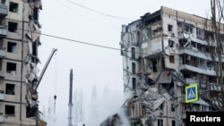 Aftermath of Dnipro apartment block destruction following missile strike