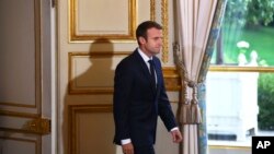 FILE - France's President Emmanuel Macron arrives to give a press conference with Australian Prime Minister Malcolm Turnbull, at the Elysee Palace, in Paris, July 8, 2017.