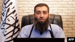 An image grab taken from a propaganda video uploaded on Sept. 9, 2013 by Syria's Islamic Front shows the new leader of Ahrar al-Sham group, Hashem al-Sheikh, known as Abu Jaber, speaking at an undisclosed location in Syria. 