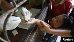 Children living in the Thai-Burma border come to a malaria clinic to get tested in Sai Yoke district, Kanchanaburi Province, October 26, 2012.