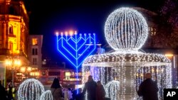 FILE - The first candles of a Hanukkah menorah are lit on the Opera square in Frankfurt, Germany, December 10, 2023.