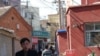 Man rides through the heart of Caochangdi Village