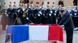 French President Francois Hollande pays his respect at the coffin of one of the two soldiers that died on Dec. 9 in Central African Republic, at the Invalides in Paris. 