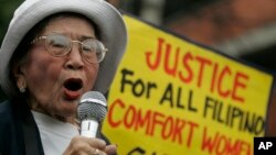 FILE - Anastacia Cortez, 92, who says she was held as a "comfort woman" by the Japanese military during World War II, speaks as members of the Lila Pilipina hold a rally at the Mendiola bridge, near the Malacanang Presidential palace in Manila, Philippi