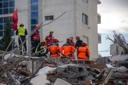 Rescuers from France and Switzerland operate at a collapsed building after the 6.4-magnitude earthquake in Durres, western Albania, Nov. 29, 2019.