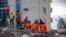 Rescuers from France and Switzerland operate at a collapsed building after the 6.4-magnitude earthquake in Durres, western Albania, Nov. 29, 2019. 