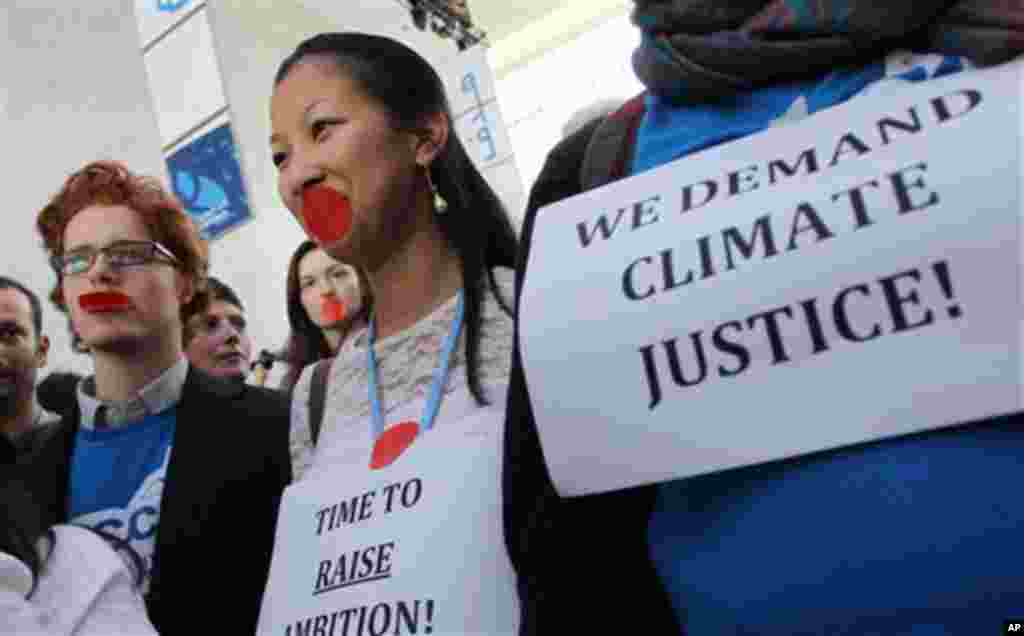 Local and international activists march inside a conferences center to demand urgent action to address climate change at the U.N. climate talks in Doha, Qatar, December 7, 2012.
