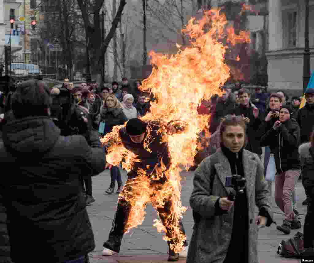 A man who called himself Oleksandr Burlakov sets himself on fire during a protest rally outside the presidential office in Kyiv, Ukraine, to draw the attention of the authorities to his plight of the land ownership.