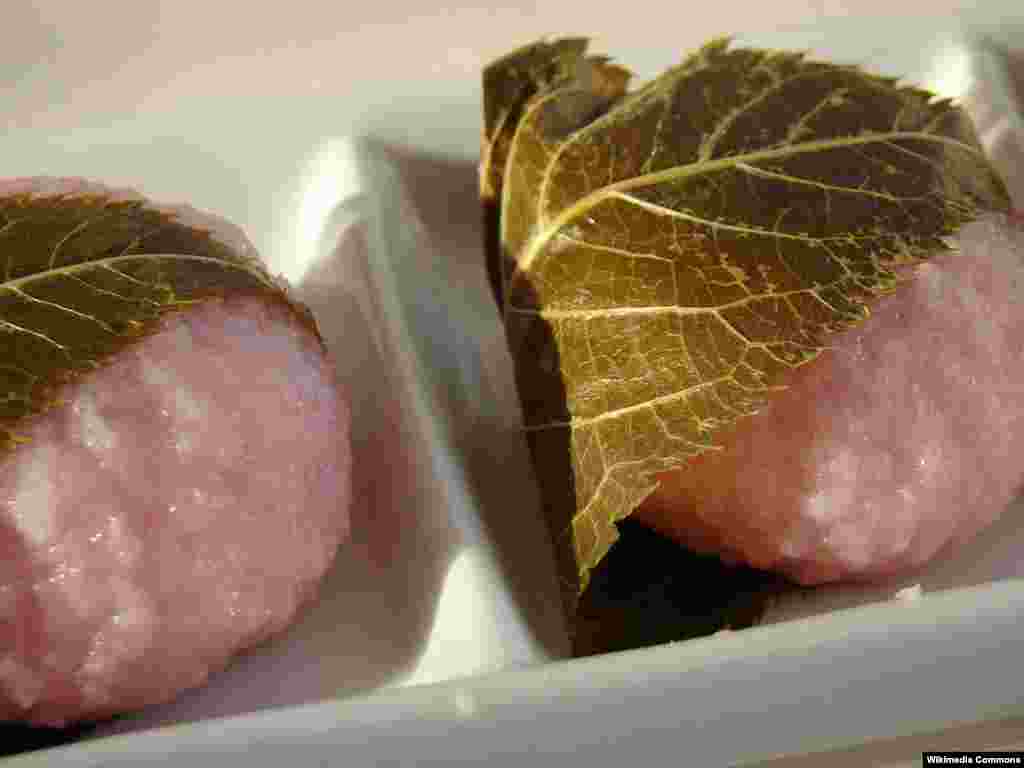 Sakura Mochi pink rice cake with a red bean paste center, and wrapped in a pickled cherry blossom leaf.