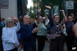 People wave as the motorcade with the Democratic presidential nominee, Vice President Kamala Harris, arrives near her hotel in Philadelphia, Sept. 9, 2024, ahead of the presidential debate with Republican nominee Donald Trump.