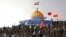 Members of the Basij, the paramilitary unit of Iran's Revolutionary Guard, gather around a replica of Jerusalem's gold-topped Dome of the Rock mosque as one of them waves an Iranian flag from on top of the dome during a military exercise, outside Qom, Iran, Nov. 20, 2015.