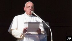 Pope Francis speaks during the Angelus noon prayer from his studio window overlooking St. Peter's square at the Vatican, Jan. 4, 2015.