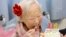 FILE - Japanese Misao Okawa, the world's oldest woman, eats her birthday cake as she celebrates her 116th birthday in Osaka, western Japan, in this photo taken by Kyodo March 5, 2014. 