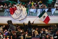 Protesters interrupt a Senate session in which lawmakers were debating the government's proposed judicial reform, which would make judges stand for election, in Mexico City, Sept. 10, 2024.