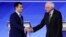 FILE - Democratic presidential candidates Pete Buttigieg, left, and Bernie Sanders shake hands on stage, Feb. 7, 2020, before the start of a Democratic presidential primary debate at Saint Anselm College in Manchester, N.H.